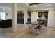 A dining room with a large wooden table, white chairs, and barn doors leading to a bar area at 2912 Epps Clark Rd, Siler City, NC 27344