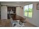 A dining room with a large wooden table, white chairs, and barn doors leading to a bar area at 2912 Epps Clark Rd, Siler City, NC 27344