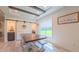 Bright dining area featuring a rustic wood table, and a view of the outdoors through a large window at 2912 Epps Clark Rd, Siler City, NC 27344