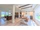 Open dining room with modern light fixtures, wood table, and sliding barn doors at 2912 Epps Clark Rd, Siler City, NC 27344