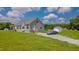 Charming home with a spacious front yard, complemented by a private driveway and greenery at 2912 Epps Clark Rd, Siler City, NC 27344