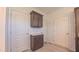 Hallway with storage cabinet and three white doors leading to various rooms at 2912 Epps Clark Rd, Siler City, NC 27344