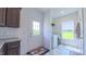 Clean laundry room with modern appliances, a window, and tile floors at 2912 Epps Clark Rd, Siler City, NC 27344