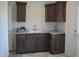 Efficient laundry room with ample cabinet storage and counter space for folding, ensuring functionality at 2912 Epps Clark Rd, Siler City, NC 27344