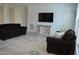 A spacious living room with comfortable seating, an entertainment center, and a neutral color scheme at 2912 Epps Clark Rd, Siler City, NC 27344