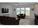 A spacious living room with comfortable seating, an entertainment center, and a neutral color scheme at 2912 Epps Clark Rd, Siler City, NC 27344