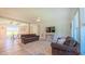 Bright living room with modern ceiling fan, neutral paint, and dark brown sofas at 2912 Epps Clark Rd, Siler City, NC 27344