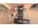 Organized walk-in closet featuring multiple shelves and hanging racks for storage at 2912 Epps Clark Rd, Siler City, NC 27344