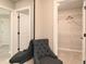 Hallway view featuring a mirror, a gray chair, and an open closet with wire shelving at 3006 Dog Rose Dr # 308, Durham, NC 27703