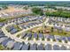 Expansive aerial view of a neighborhood showcasing modern homes, green spaces, and community amenities at 345 Warm Wind Dr, Clayton, NC 27527