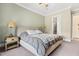 Neutral-toned bedroom with a ceiling fan, side tables with lamps, and soft carpeting at 345 Warm Wind Dr, Clayton, NC 27527