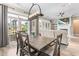 Dining room features a wooden table with chairs, open patio doors, and a modern light fixture at 345 Warm Wind Dr, Clayton, NC 27527