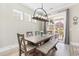 Dining area with a rustic table and chairs next to sliding glass doors leading to outdoor patio at 345 Warm Wind Dr, Clayton, NC 27527