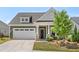 Charming home featuring a two-car garage, welcoming front porch, and manicured lawn at 345 Warm Wind Dr, Clayton, NC 27527