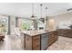 Bright kitchen with granite countertops, stainless steel appliances, and an island with a sink at 345 Warm Wind Dr, Clayton, NC 27527