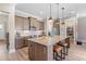 Modern kitchen with granite countertops, stainless steel appliances, and an oversized island at 345 Warm Wind Dr, Clayton, NC 27527