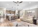 Open living area with kitchen island, dining table, sofa, and natural light from many windows at 345 Warm Wind Dr, Clayton, NC 27527