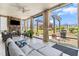 Relaxing screened porch with a stone fireplace, comfortable seating, and beautiful backyard views at 345 Warm Wind Dr, Clayton, NC 27527