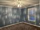 Cozy bedroom with plush carpeting, soft lighting, and a window providing natural light at 3489 Forestdale Dr # 2D, Burlington, NC 27215