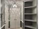 Hallway with built-in shelving, closet, and attractive overhead lighting fixture at 3489 Forestdale Dr # 2D, Burlington, NC 27215