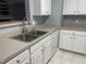 Modern kitchen featuring stainless steel sink, white appliances, and spacious countertops at 3489 Forestdale Dr # 2D, Burlington, NC 27215