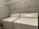 Functional laundry room with washer, dryer, and convenient overhead shelving at 3489 Forestdale Dr # 2D, Burlington, NC 27215