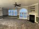 Spacious living room with modern fireplace, large windows, and stylish ceiling fan at 3489 Forestdale Dr # 2D, Burlington, NC 27215