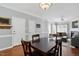 Inviting dining area features a modern table set and opens to a cozy living room with a fireplace at 368 Bayleigh Ct, Garner, NC 27529