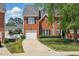 Charming two-story red brick home featuring a one-car garage and well-maintained landscaping at 368 Bayleigh Ct, Garner, NC 27529