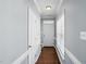 Inviting hallway with hardwood floors leading to a white front door and window at 368 Bayleigh Ct, Garner, NC 27529