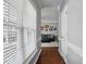 Bright hallway with hardwood floors leading to a cozy living room, bathed in natural light at 368 Bayleigh Ct, Garner, NC 27529