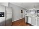 Open-concept kitchen with stainless steel appliances, a modern sink, and hardwood flooring at 368 Bayleigh Ct, Garner, NC 27529