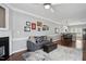 Open-concept living area featuring hardwood floors, a dining area, and a comfortable sofa at 368 Bayleigh Ct, Garner, NC 27529