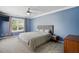 Comfortable primary bedroom boasts ample light from the window, carpeted floors, and a TV at 368 Bayleigh Ct, Garner, NC 27529