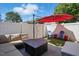 Cozy backyard patio area with comfortable seating, modern fire pit and red umbrella at 368 Bayleigh Ct, Garner, NC 27529
