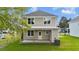 View of backyard including the home's AC unit and a covered patio at 408 W Stallings St, Clayton, NC 27520
