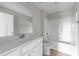 Clean bathroom with white vanity, vinyl flooring, and a shower-tub combo at 408 W Stallings St, Clayton, NC 27520