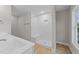 Modern bathroom featuring walk-in shower with glass door and white vanity sink at 408 W Stallings St, Clayton, NC 27520
