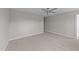An empty bedroom with neutral walls, carpet, ceiling fan, and a doorway at 408 W Stallings St, Clayton, NC 27520
