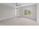 Bright bedroom features a ceiling fan, carpeted floor, and window offering natural light at 408 W Stallings St, Clayton, NC 27520