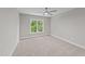 Bright bedroom with carpet, neutral walls, white trim, and a ceiling fan at 408 W Stallings St, Clayton, NC 27520