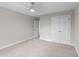Neutral bedroom with carpeting, closet, ceiling fan, and an open doorway at 408 W Stallings St, Clayton, NC 27520