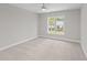 Bright bedroom with carpet, neutral walls, white trim, ceiling fan, and large window at 408 W Stallings St, Clayton, NC 27520
