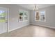 Bright dining room featuring wood floors, chandelier lighting, and natural light from two large windows at 408 W Stallings St, Clayton, NC 27520