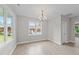 Bright dining room with a chandelier, large windows, and light wood flooring at 408 W Stallings St, Clayton, NC 27520