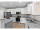 Well-equipped kitchen with white cabinets, stainless appliances, and granite countertops at 408 W Stallings St, Clayton, NC 27520