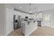 Bright kitchen features white cabinets, stainless steel appliances, and a center island at 408 W Stallings St, Clayton, NC 27520