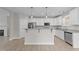 Open kitchen with white cabinets, granite countertops, and stainless steel appliances at 408 W Stallings St, Clayton, NC 27520