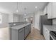 Open concept kitchen with granite counters, white cabinets, and stainless steel appliances at 408 W Stallings St, Clayton, NC 27520