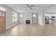 Spacious living room featuring a modern fireplace, ceiling fan, and light wood flooring at 408 W Stallings St, Clayton, NC 27520